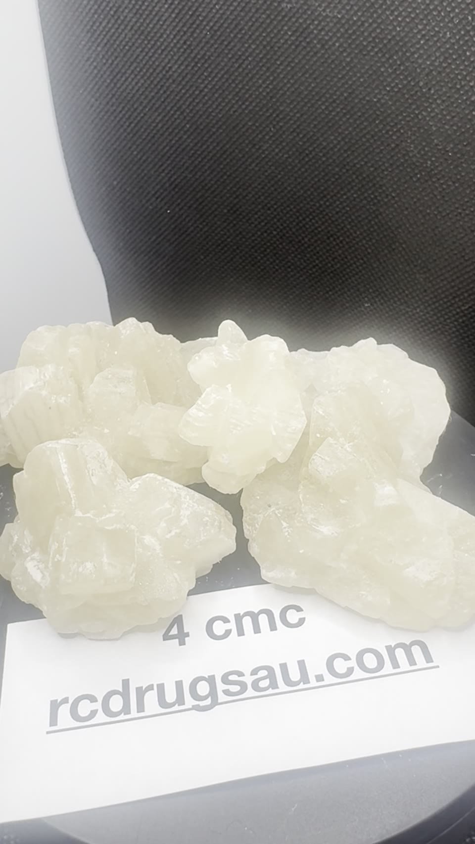 4-CMC crystals with a batch card.